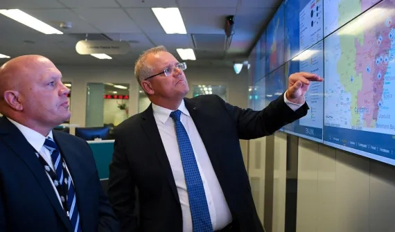 Scot Morrison consulting Esri maps during the bushfires.