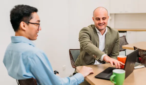 Esri Staff Pointing at Laptop